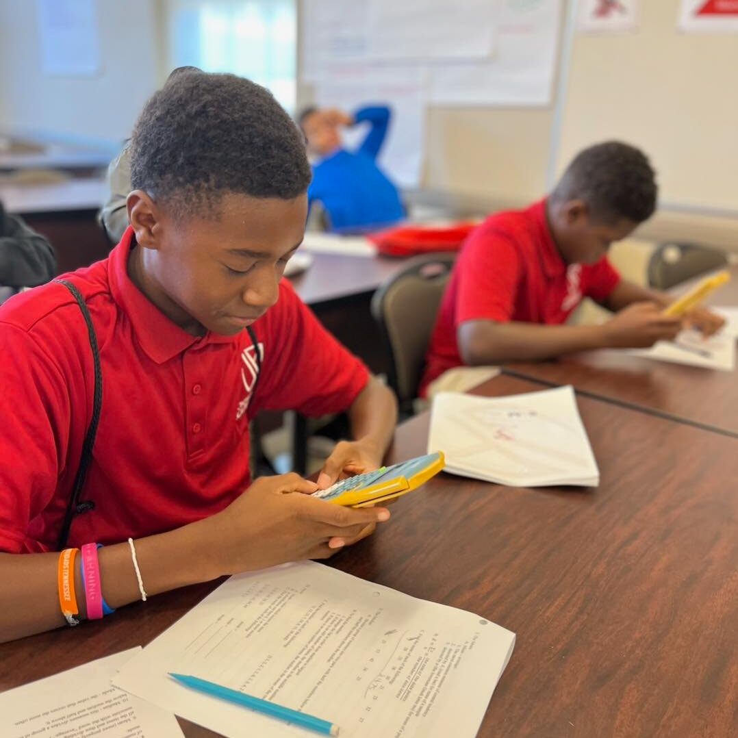 Scholar using calculator in STEM class.