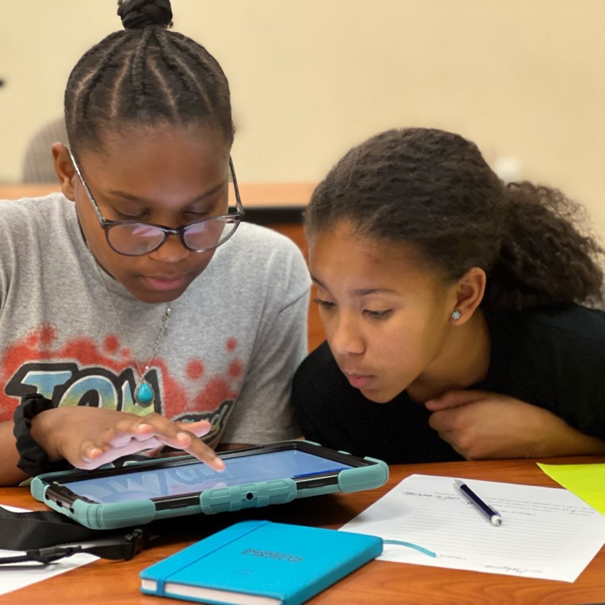 Two girls studying on iPad.